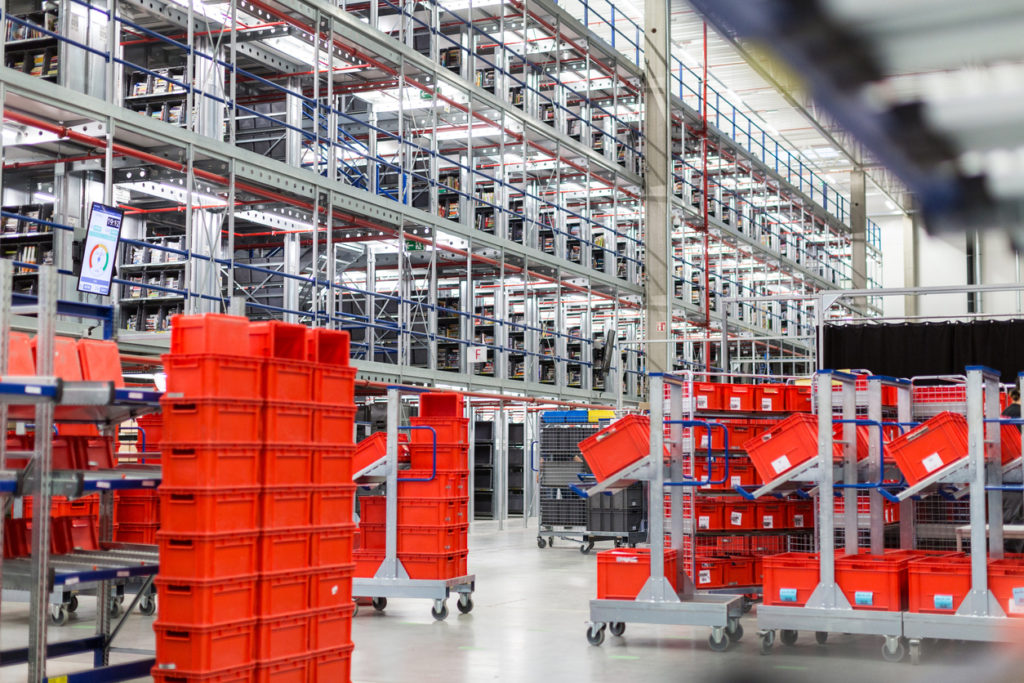 Interior of large distribution warehouse with movement trolleys and shelves.