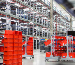 Interior of large distribution warehouse with movement trolleys and shelves.