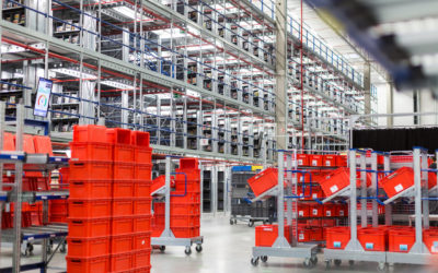 Interior of large distribution warehouse with movement trolleys and shelves.